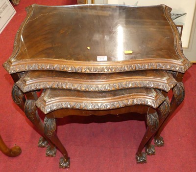 Lot 1272 - A floral carved walnut serpentine nest of...