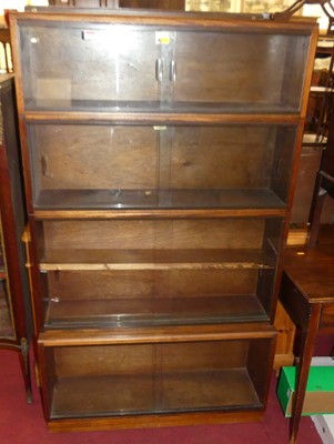 Lot 1305 - A mid-20th century four-tier stacking bookcase,...