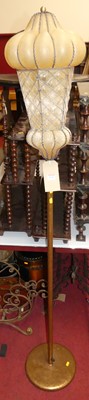 Lot 1345 - A gilt decorated tubular metal standard lamp,...