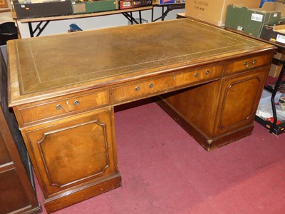Lot 1380 - A mahogany partner's desk, having a gilt...