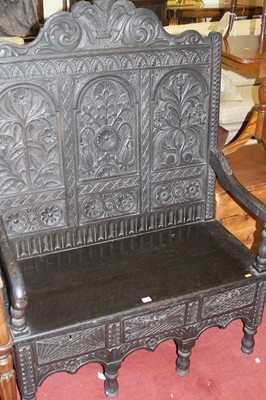 Lot 1423 - An ebonised, joined, and relief carved oak...