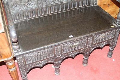 Lot 1423 - An ebonised, joined, and relief carved oak...