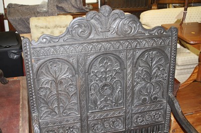 Lot 1423 - An ebonised, joined, and relief carved oak...
