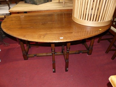 Lot 1436 - A joined oak wake table, having oval...