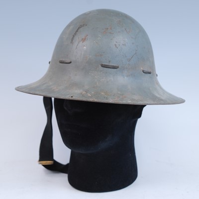 Lot 560 - A WW II Zuckerman steel helmet, in grey finish...