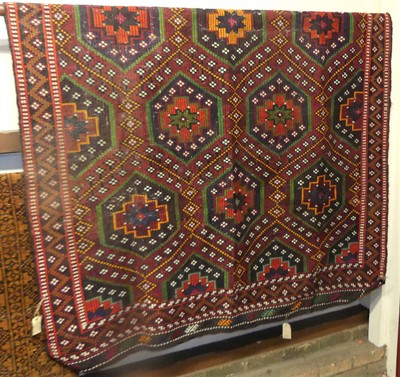 Lot 1223 - An Afghan Soumak carpet, the predominantly red...
