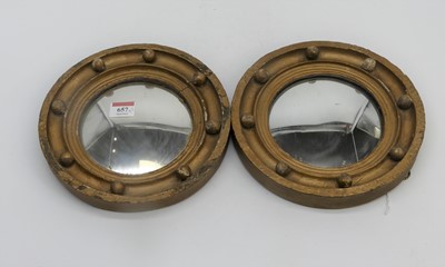Lot 657 - Two porthole style mirrors with gilt decoration