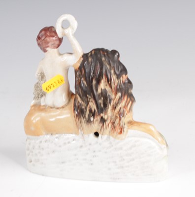 Lot 4061 - A Staffordshire model of a lion and a lamb,...