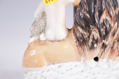 Lot 4061 - A Staffordshire model of a lion and a lamb,...