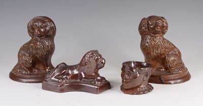 Lot 4058 - A pair of brown glazed stoneware models of...