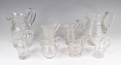 Lot 4096 - A collection of eight cut glass jugs, 19th...
