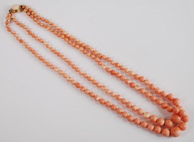 Lot 333 - A two-row coral necklace, featuring a row of...
