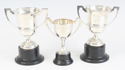 Lot 1256 - A near pair of George V. silver twin handled...