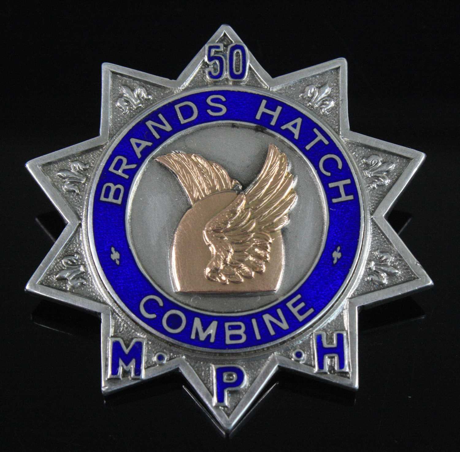Lot 1259 - A George V. silver badge of ten point star...