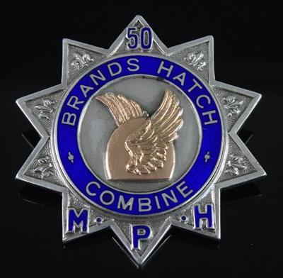 Lot 1259 - A George V. silver badge of ten point star...