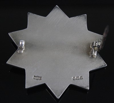 Lot 1259 - A George V. silver badge of ten point star...