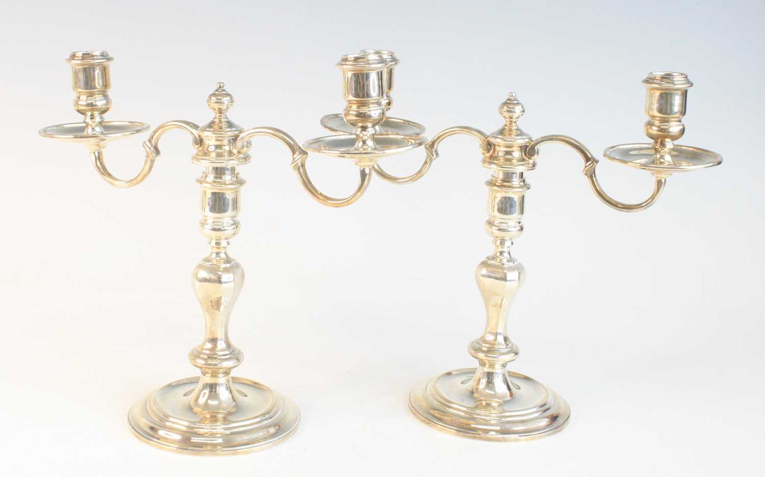 Lot 2097 - A pair of George VI silver twin-branch...