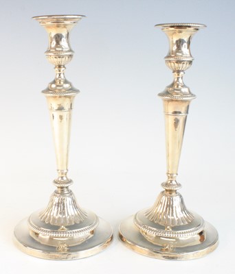 Lot 2098 - A pair of silver pedestal candlesticks on...