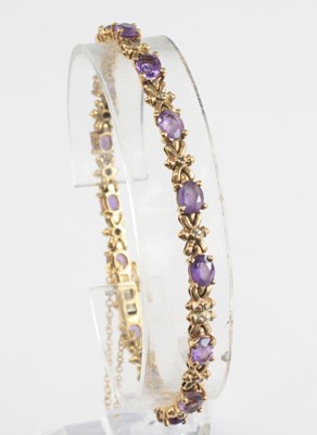 Lot 2261 - A modern 9ct gold, amethyst and diamond point...