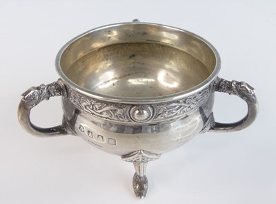Lot 88 - An Irish Arts & Crafts silver miniature tyg,...
