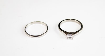 Lot 2164 - A platinum diamond solitaire ring, together...