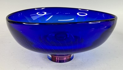 Lot 72 - A large heavy blue glass footed fruit bowl by...