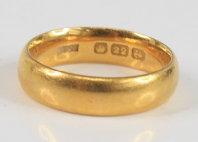 Lot 2284 - A 22ct 5.4mm court shaped wedding band, size...