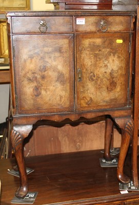 Lot 1180 - A small 1930s figured walnut double door...