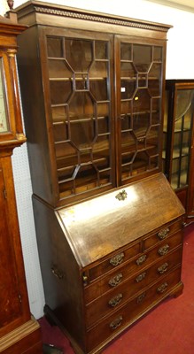 Lot 1112 - A George III mahogany bureau bookcase, having...