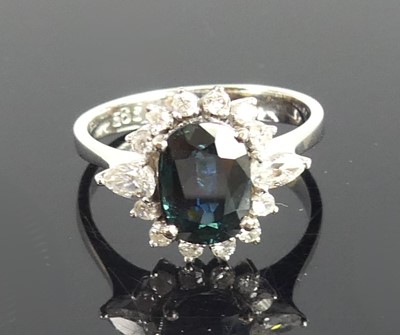 Lot 2253 - A white metal, sapphire and diamond oval...