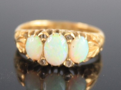 Lot 2239 - An 18ct yellow gold Edwardian opal three-stone...