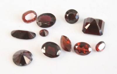 Lot 469 - A collection of loose vari-cut garnets, the...