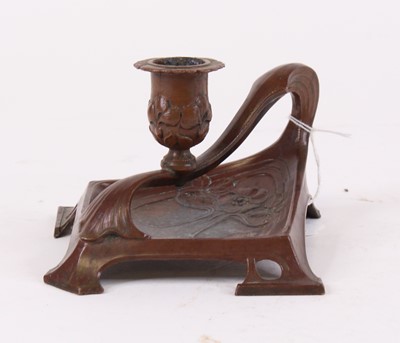 Lot 52 - An Art Nouveau copper chamberstick, relief...