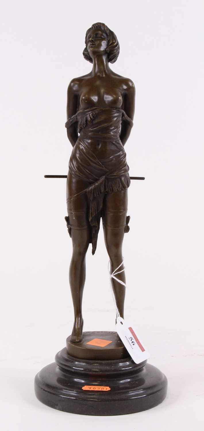 Lot 56 - A bronzed figure of a lady, shown holding a...