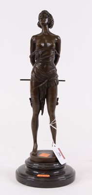 Lot 56 - A bronzed figure of a lady, shown holding a...