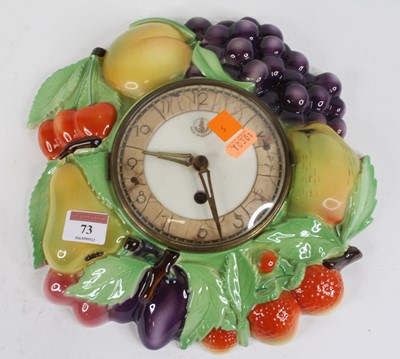 Lot 73 - A German pottery wall clock, relief decorated...