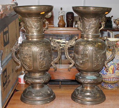 Lot 147 - A pair of Chinese brass vases, each relief...