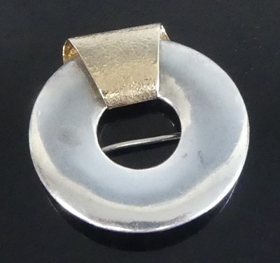 Lot 2547 - A yellow and white metal heavy circular brooch,...