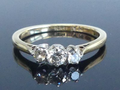 Lot 2564 - A yellow and white metal diamond three-stone...
