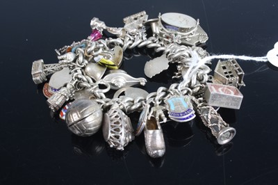 Lot 393 - A silver curb link bracelet containing large...