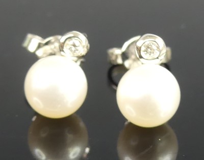 Lot 463 - A pair of white metal pearl and diamond stud...