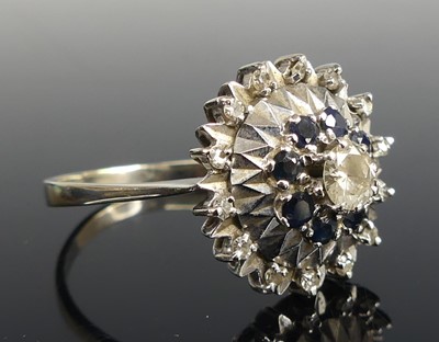 Lot 2170 - A white metal, sapphire and diamond reverse...