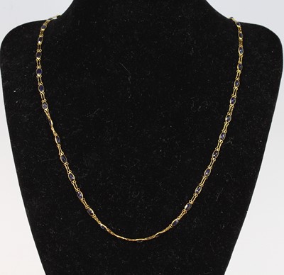 Lot 2642 - A contemporary yellow metal and blue sapphire...