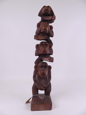 Lot 5 - A carved hardwood totem in the form of four...