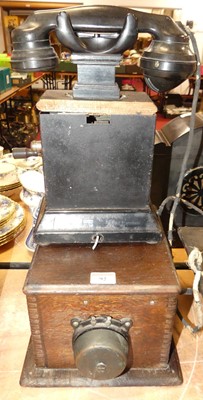 Lot 92 - An early 20th century bakelite telephone,...