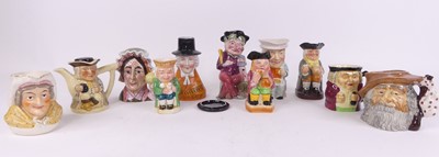 Lot 70 - A collection of pottery character jugs to...