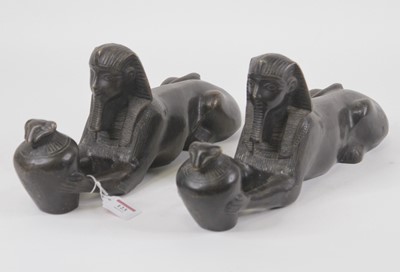 Lot 123 - A pair of bronze models of sphinx, each in...