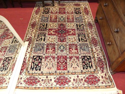 Lot 1141 - A Persian woollen cream ground pictorial rug,...