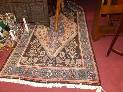 Lot 1143 - A Persian woollen brown and pink ground Shiraz...