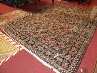 Lot 1144 - A Persian woollen faded red ground Tabriz rug,...